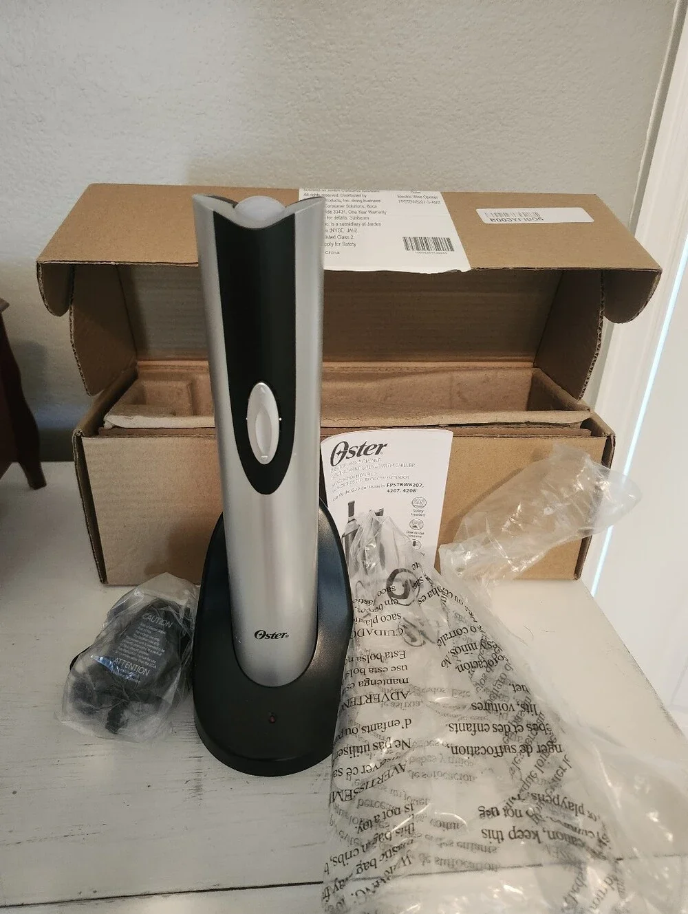 New In Box. Oster Silver and Black Electric Wine Opener with Charging Base.